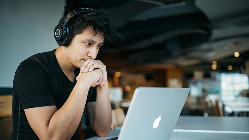 Man looking at laptop for more engaging online experience